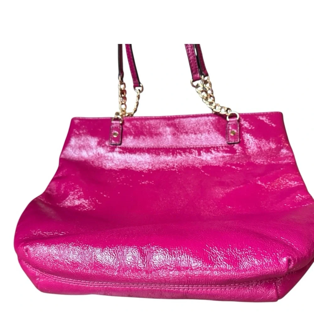 Michael Kors patent leather handbag in a sleek, glossy finish.